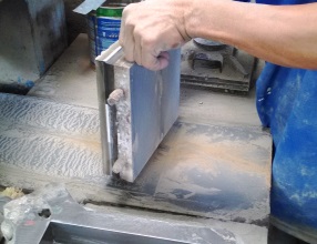 Production of encaustic tiles. The cement tiles is taken out of the mould.